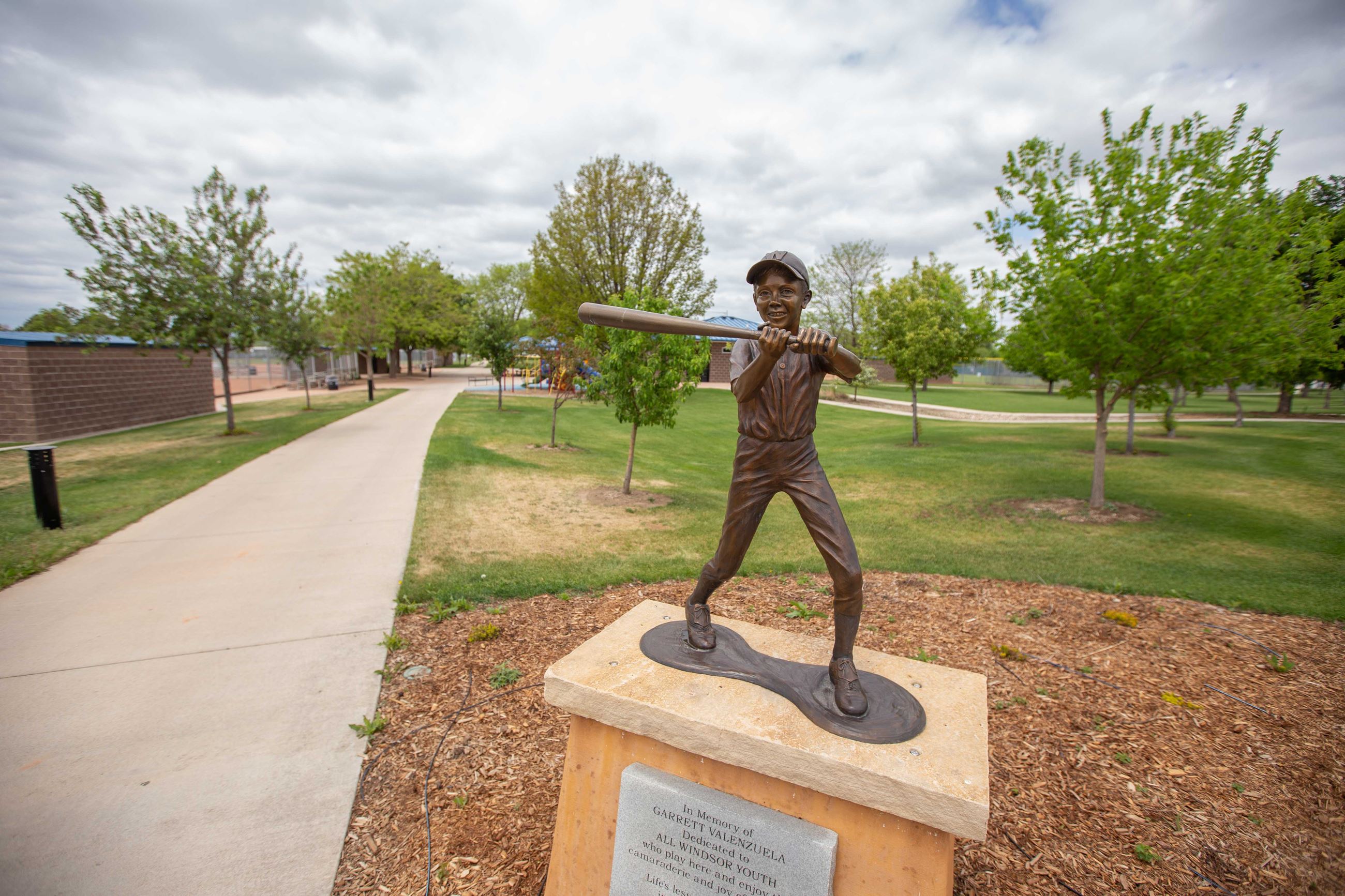 Statue of boy swinging a baseball bat